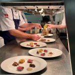 Students preparing meals at the guest chef event