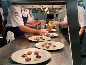 Students preparing meals at the guest chef event