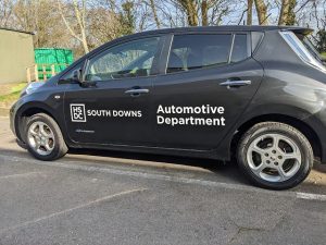 Black car with HSDC South Downs Automotive Department on the side