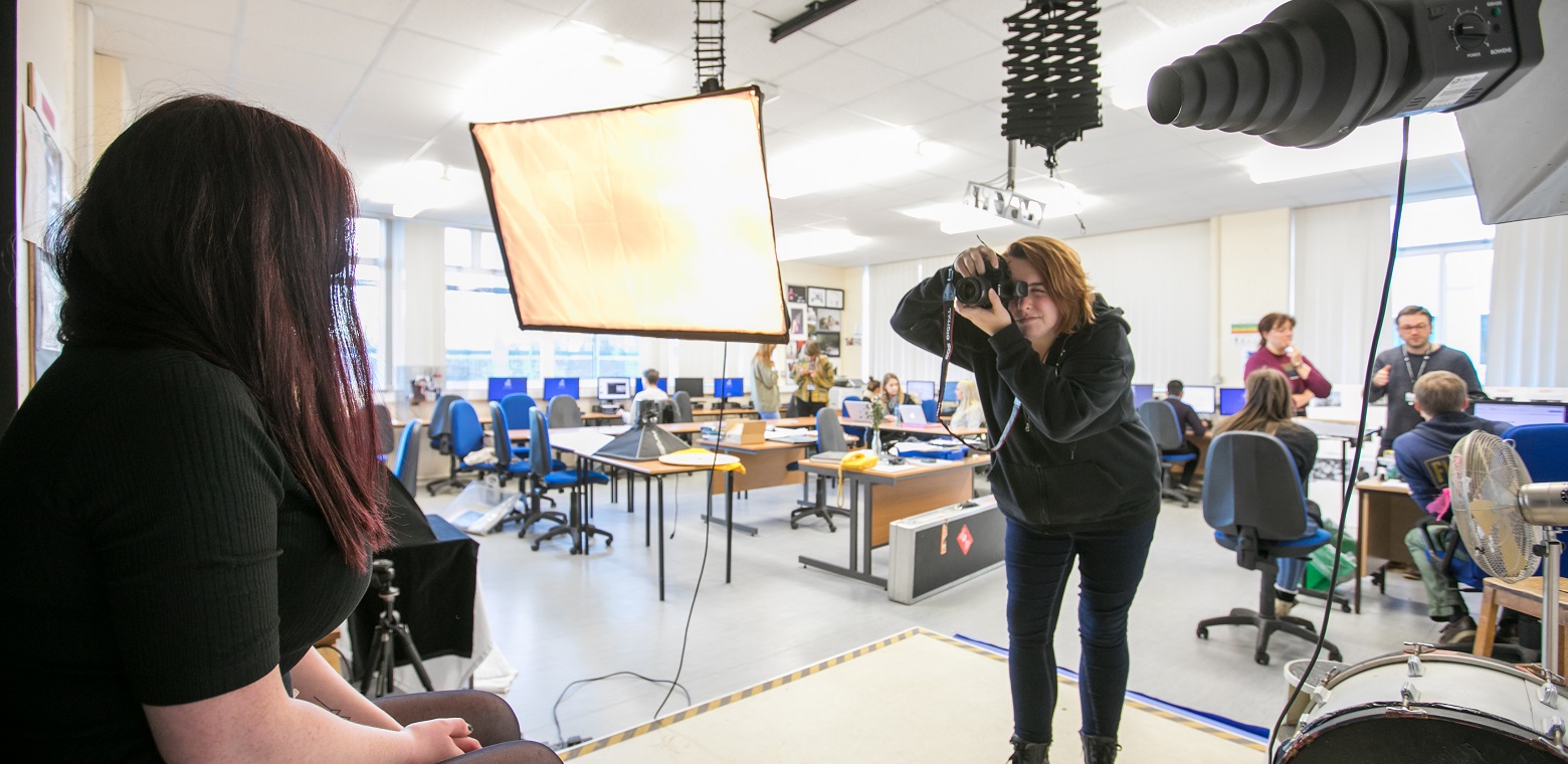 a student photographing a fellow student