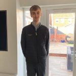 Jay smiling in his Waitrose uniform