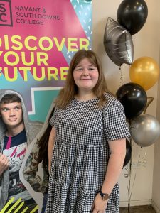 Niamh smiling by a HSDC banner