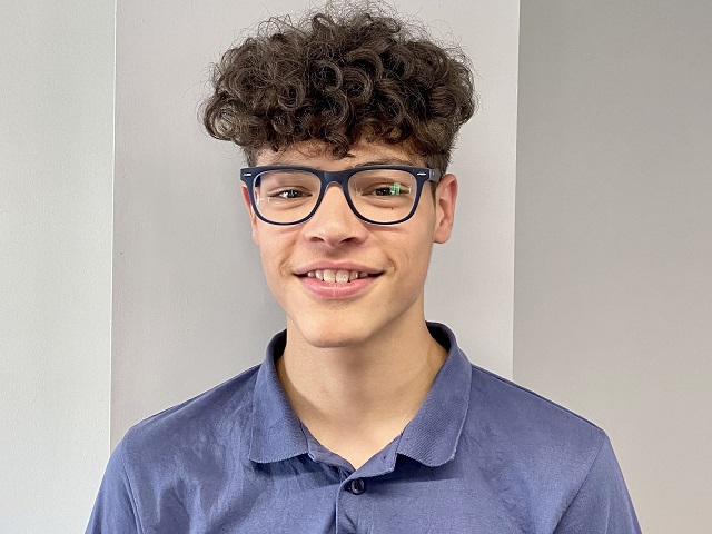 Charlie is smiling at the camera