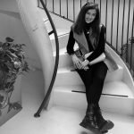Black and white photo of Grace Abbott sitting on a staircase