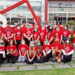 Smiling students all dressed in red