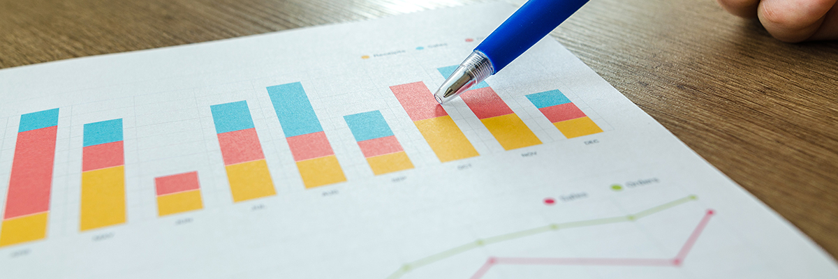Pen to paper showing various charts on this Access to HE Business course