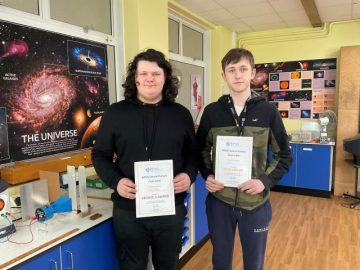 Students with their awards in classroom