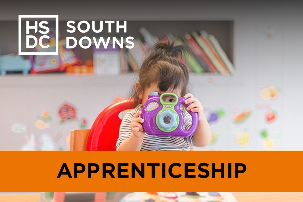 A child playing with a toy camera.