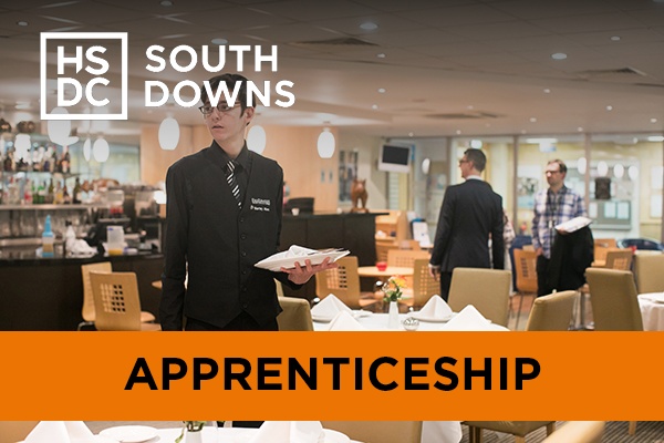 A hospitality student serving as wait staff.