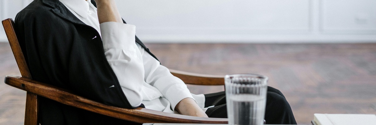 A therapist sat in a chair in thought.
