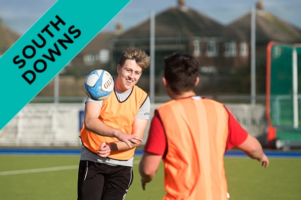 Two students playing rugby.