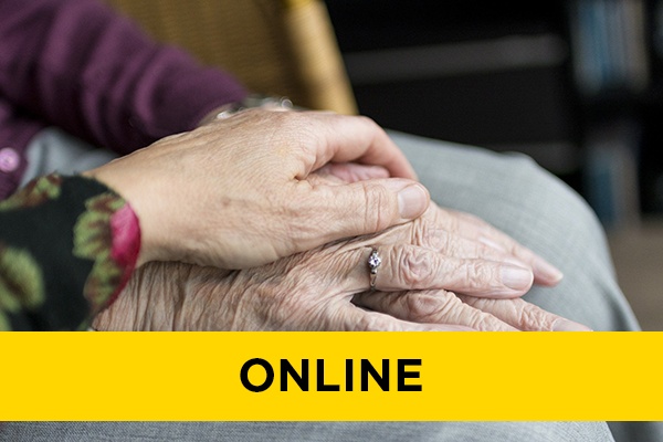 Two elderly people holding hands.
