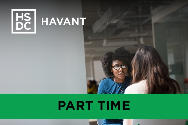 Two women speaking to eachother in a meeting.