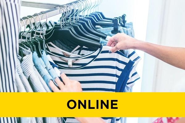 someone browsing through clothing on a rail in a store