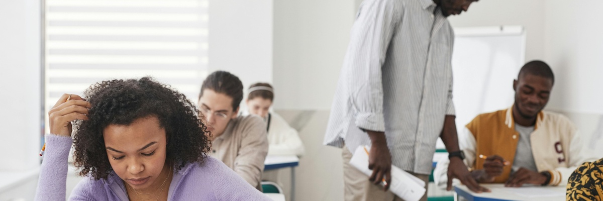 A teacher helping students in the classroom.