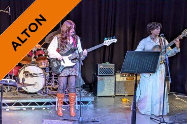 A band comprised of students on stage, performing.