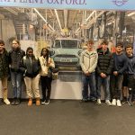 9 Alton Business students pose for a photo in the BMW MINI plant.