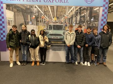 9 Alton Business students pose for a photo in the BMW MINI plant.
