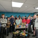 A photo of the first year T Level Engineering students wearing fake moustaches, standing next to the food delivery.