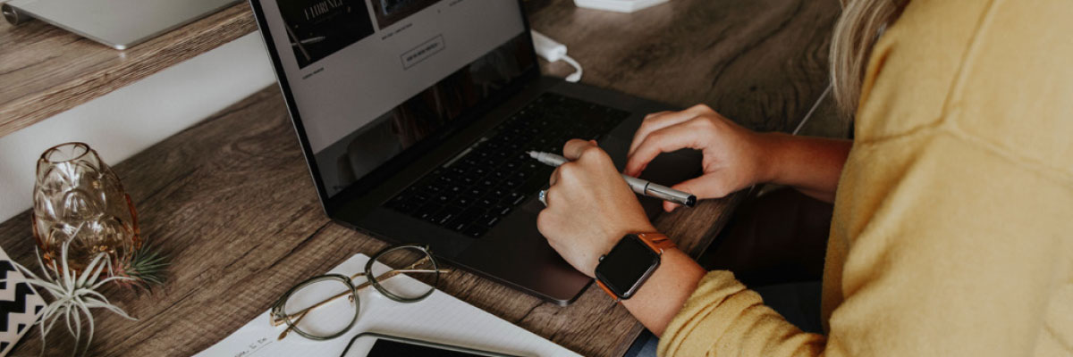 A closeup of someone using a laptop.