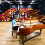 Student playing the piano in Havant's Studio Theatre.