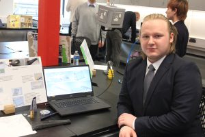 Student Adam Tier next to his 3D printed designs.