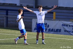 Two Hawks celebrate a goal being socred. 