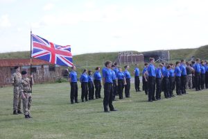 The students stand to attention. 