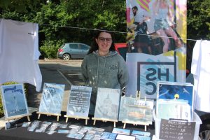 A student with their stand at the pop up market. 