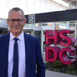 Mike Gaston standing in front of a HSDC sign at Havant Campus.