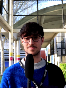 Finley Bunce outside Alton College with a microphone.