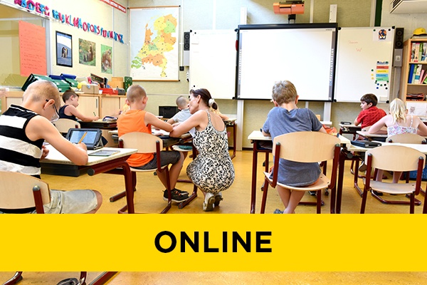 A teacher helping a student in class.