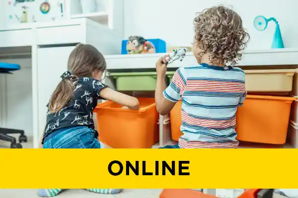 Behind shot of two children playing with toys from orange boxes.
