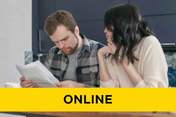 A man and a woman look over a piece of paper.