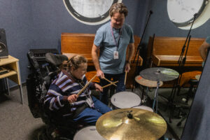 Evie playing the drums.
