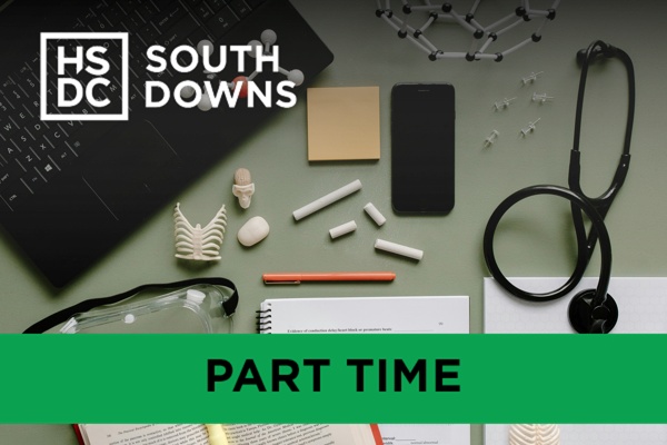 A desk with a laptop and scientific study equipment.