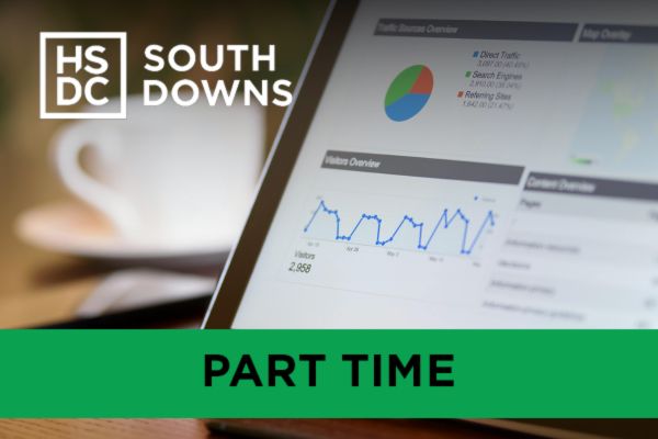 A tablet showing graphs and numerical breakdowns on a desk with a mug - Access to Higher Education in Business and Information Technology Preview Image.