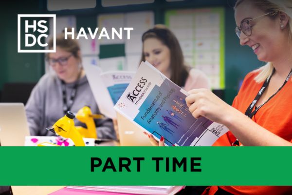 Access to Higher Education students reading a book on Anatomy for their healthcare course.