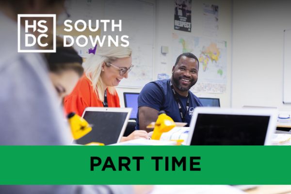 Access to Higher Education Students with laptops smiling in their Humanities and Social Sciences course.