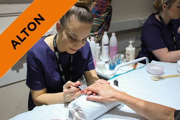 A beauty student giving a client a manicure.