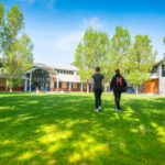 Students walking across a field at HSDC