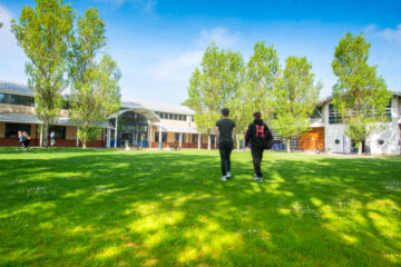 Students walking across a field at HSDC