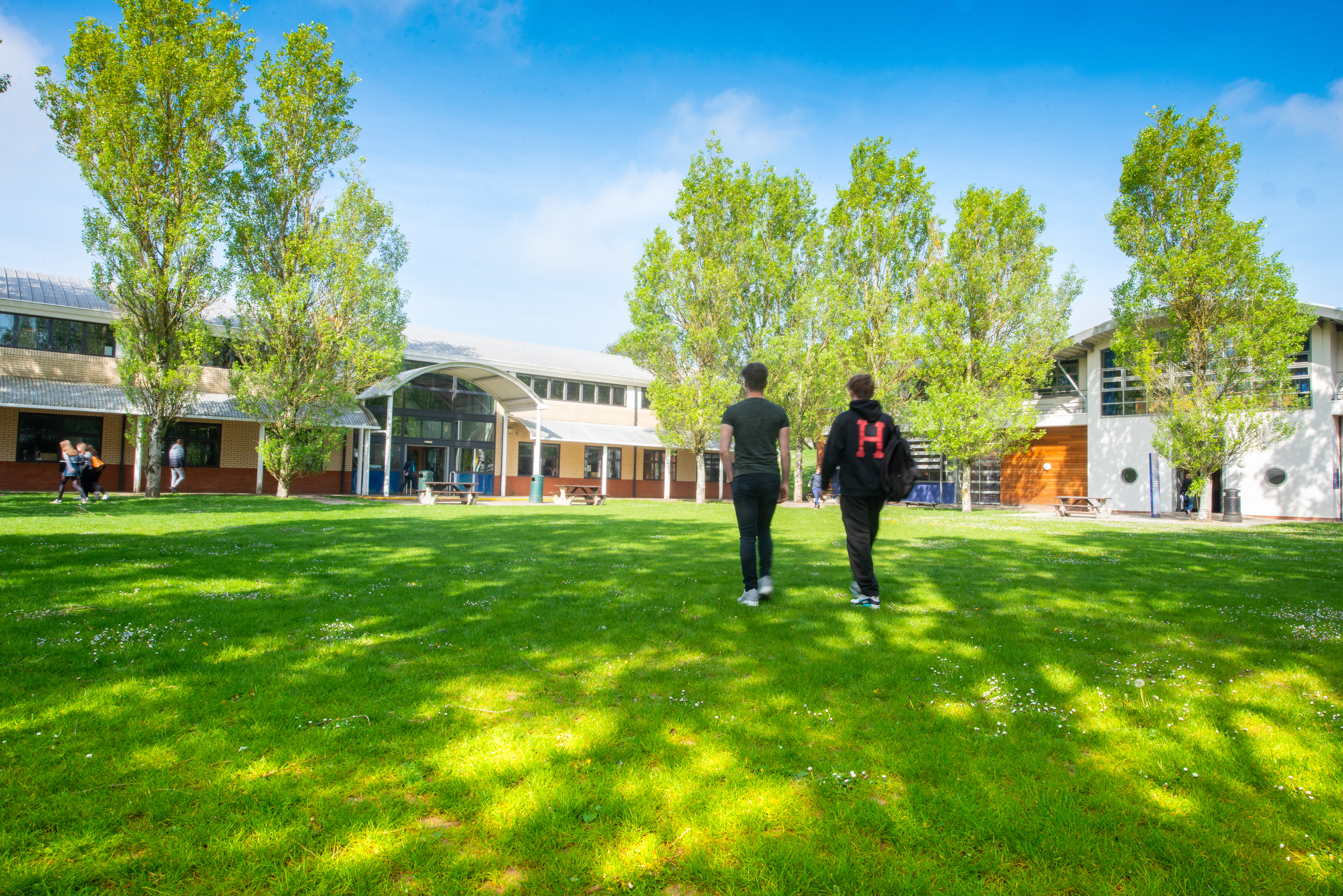 Students walking across a field at HSDC