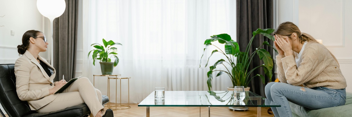 two people sat opposite each other in a counselling session