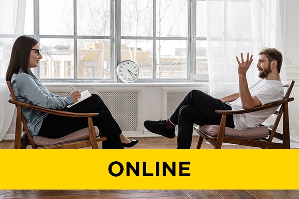 two people sat opposite each other in a counselling session