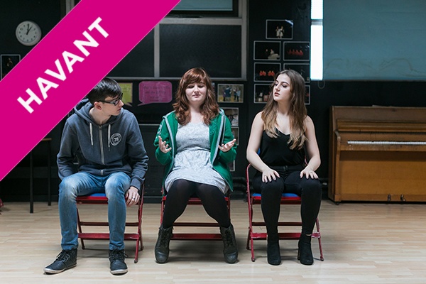 A Level Drama and Theatre Studies students sitting on chairs in a drama studio