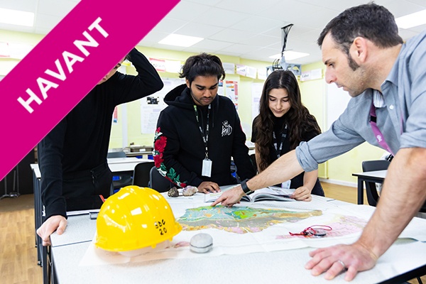 students around a table in with a lecturer