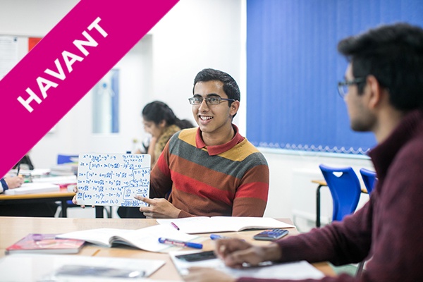 a student holding up math equations in class