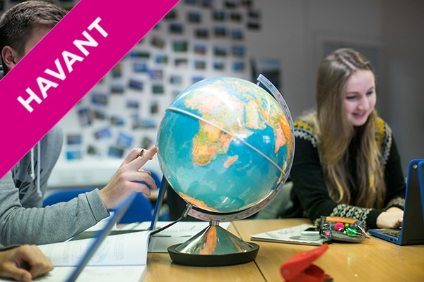 a student pointing at a globe