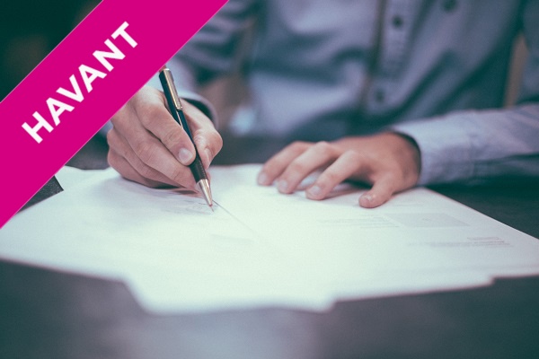 man signing a contract